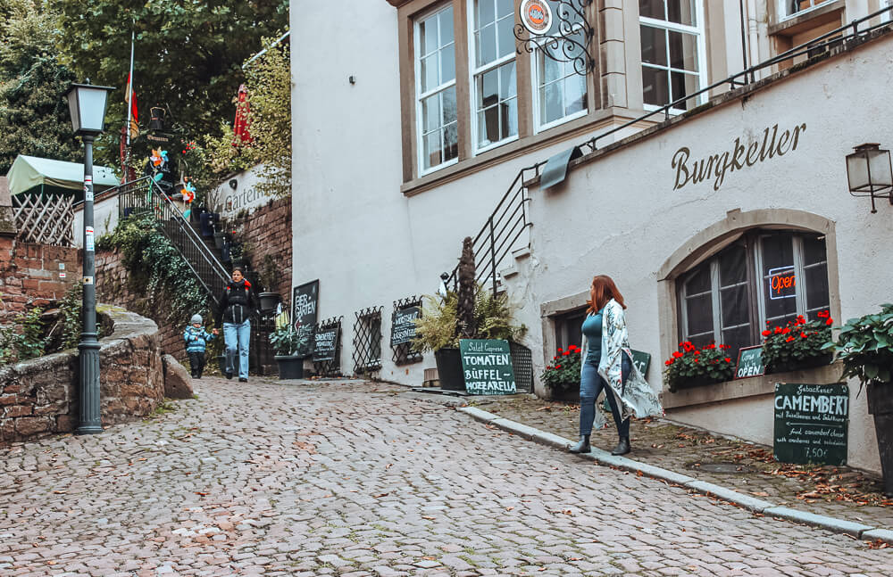 Woman wandering the cobbled streets of Heidelberg Germany