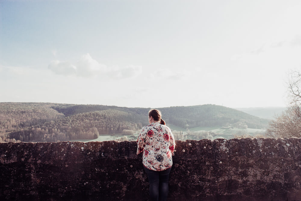 Woman in a floral top admiring the view from Breuberg Castle.