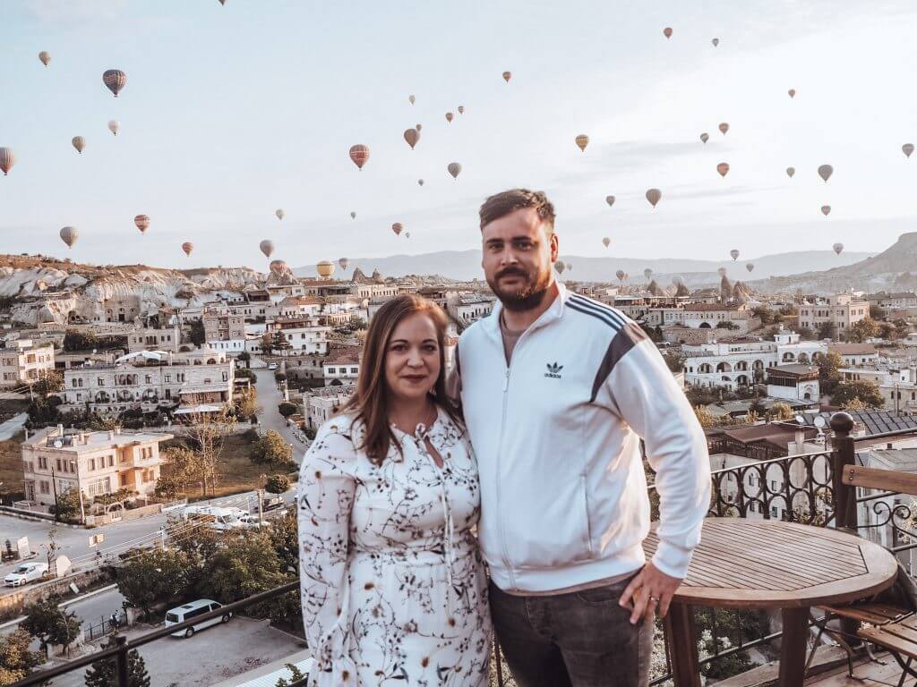 Couple watching the hot air balloons over Goreme Cappadocia.