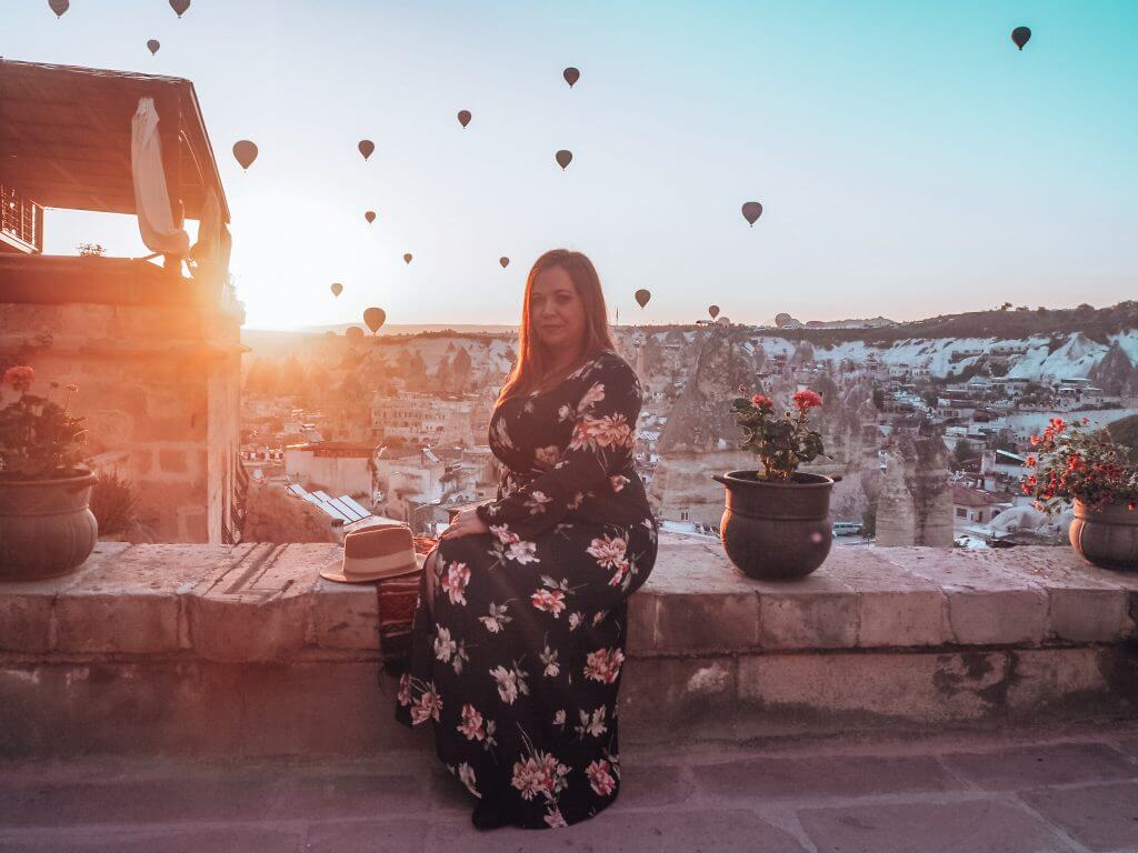 Woman in a floral dress watching the hot air ballons in Cappadocia.