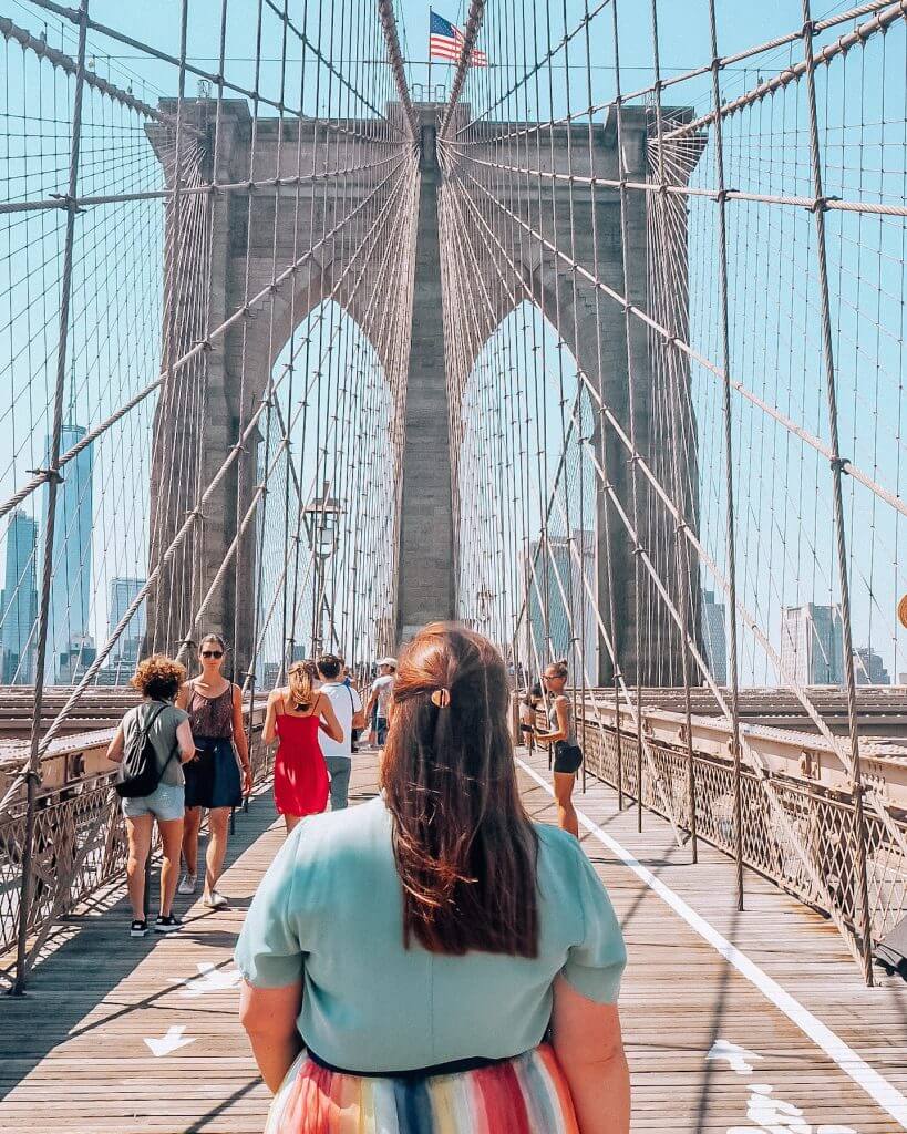 Woman standing on Brooklyn Bridge in New York City. 