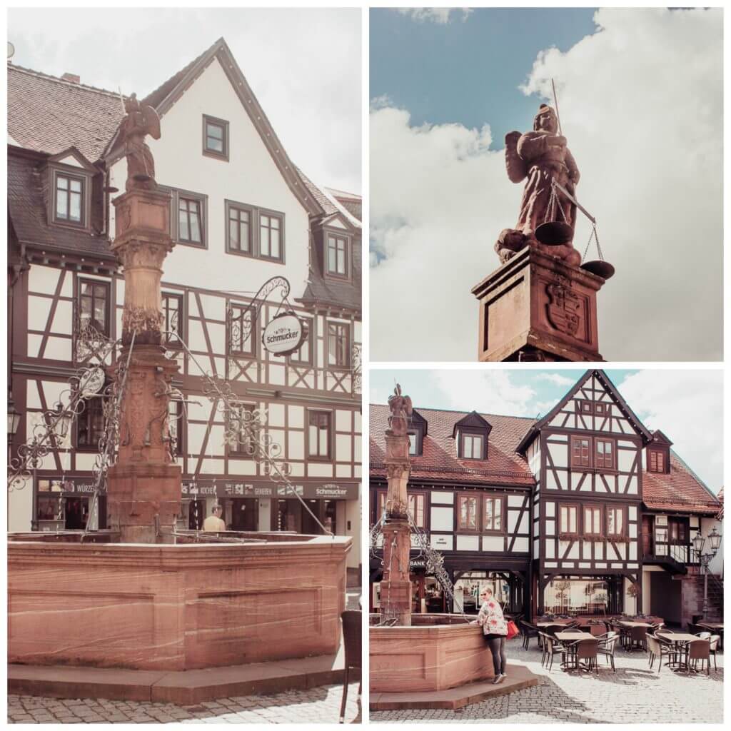 The fairytale village of Michelstadt Germany with an ornate fountain, marktbrunnen, in the town square and statue of the archangel Michael