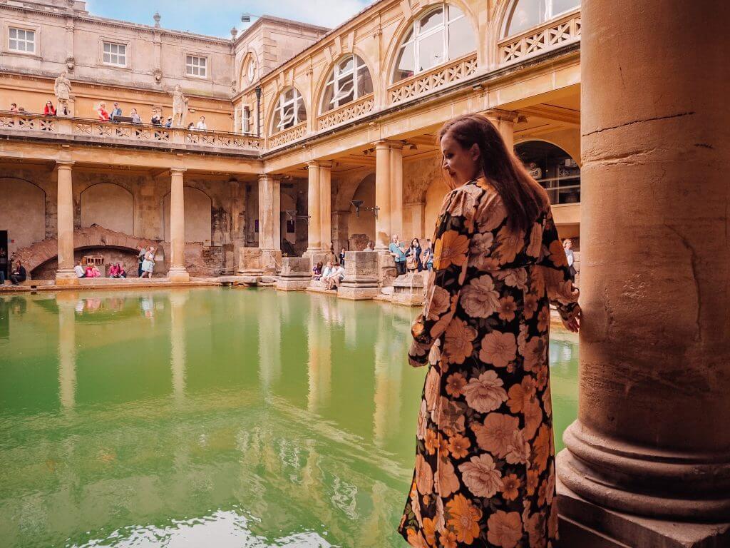 Woman in a floral dress at The Roman Baths in Bath city, one of the many things to do in Bath