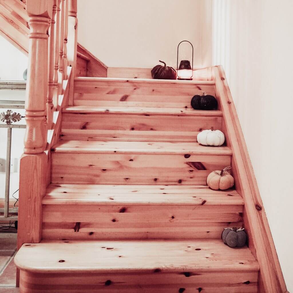 Pumpkins staggered down a staircase for fall decor