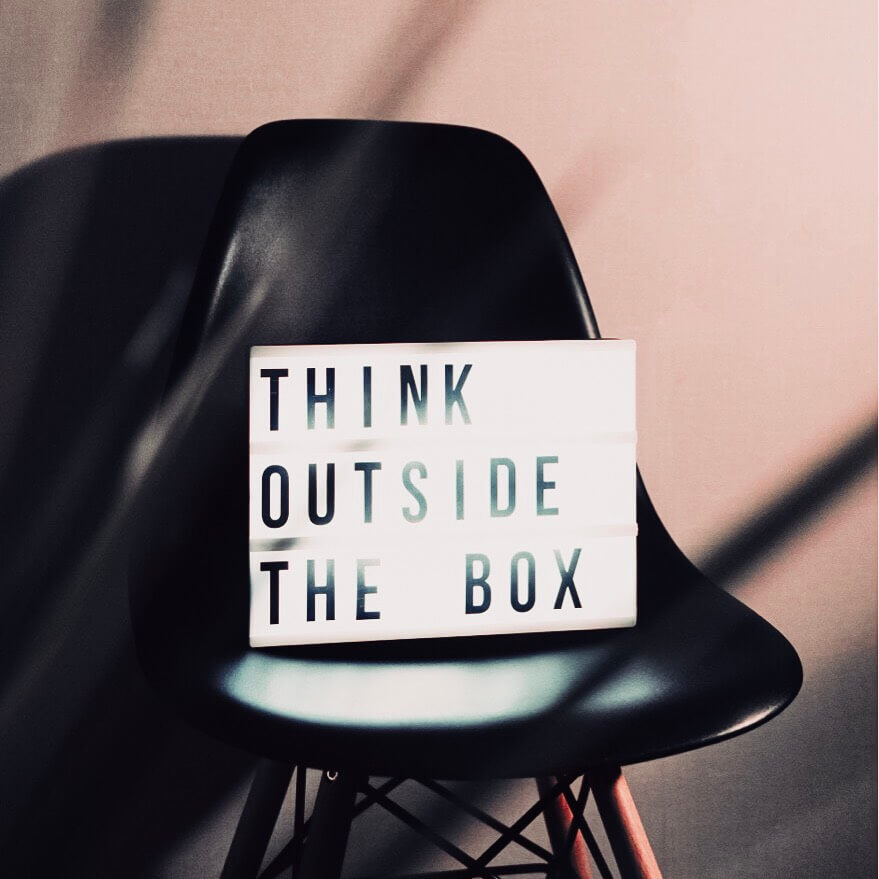 Image of  a chair with a light box stating to think outside the box. A blog post on what to do if your Instagram accounts is hacked.