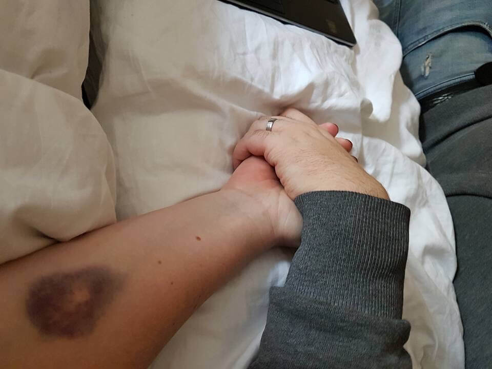 couple holding hands in hospital