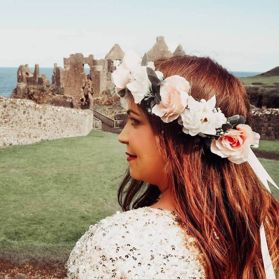 girl with flower crown looking at a castle