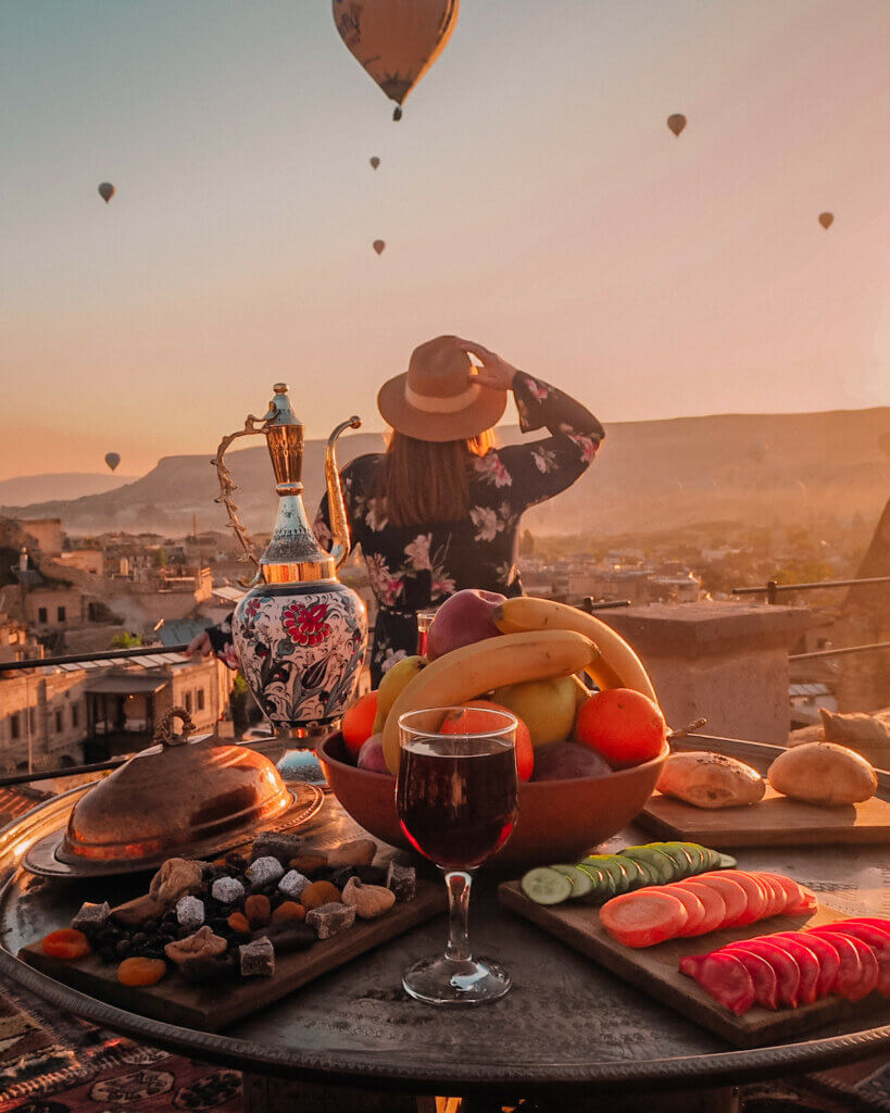 Woman surrounded by hot air balloons in Cappadocia Turkey
