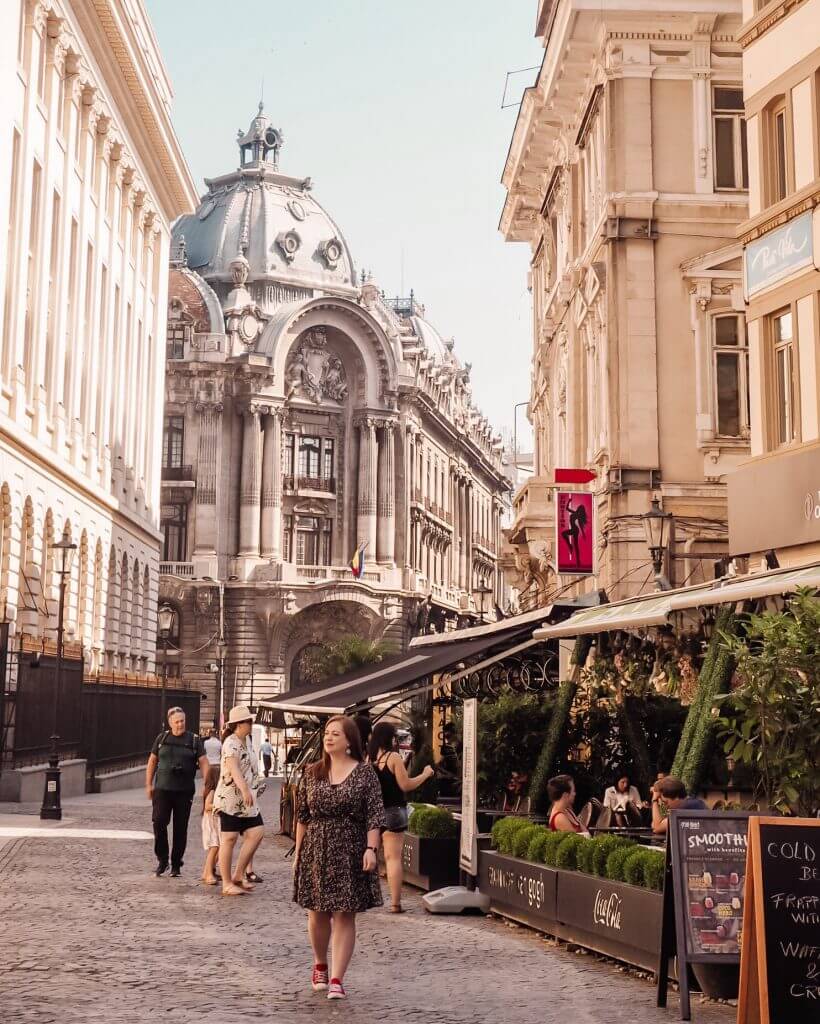 Woman walking through the Parisian streets of Bucharest