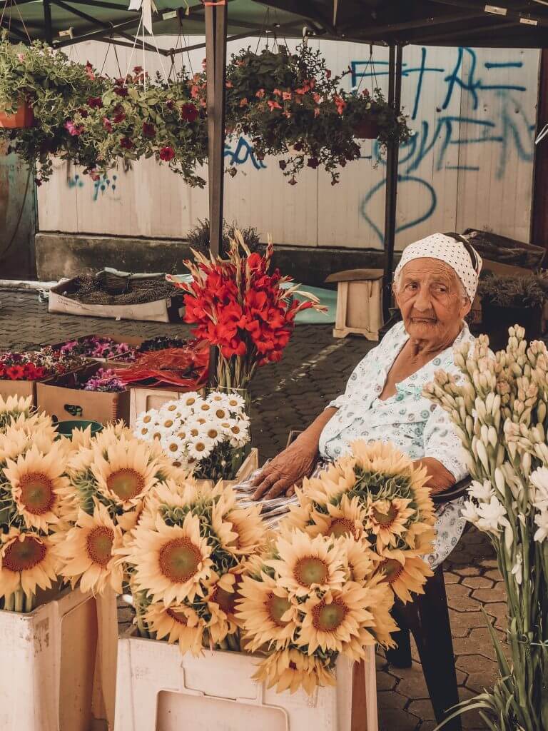 Romani woman in flower markets in Bucharest. Read more on www.allaboutrosalilla.com