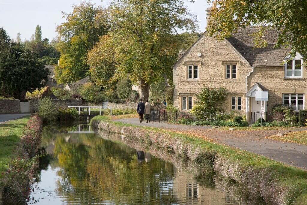 Tranquil waters of Bourton-on-the-Water, a gem among Cotswolds' best villages.