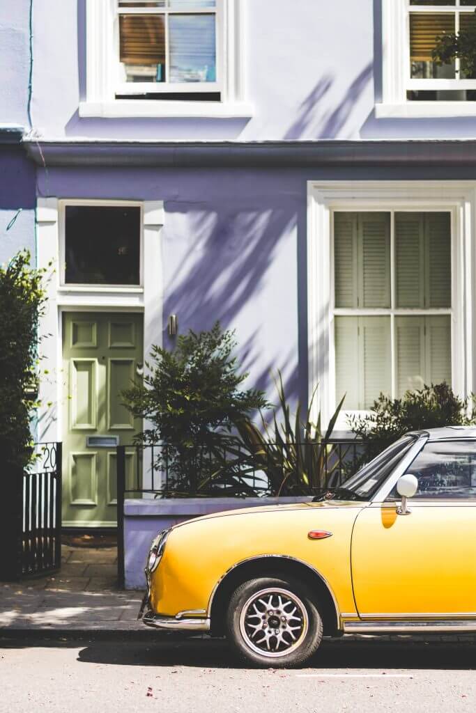 Pastel Blue house in Notting Hill London with a yellow car parked outside