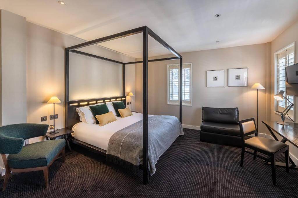 Bedroom of The Resident Soho with four poster bed