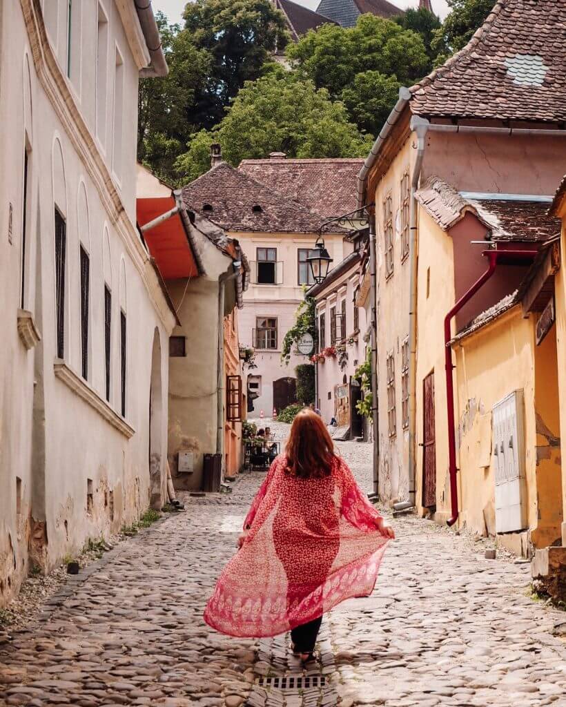 The colourful streets of Medieval Sighisoara in Transylvania Romania. 