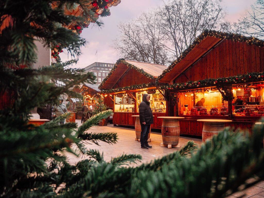 Rustic wooden huts with fairy lights at the St Petri Christmas markets