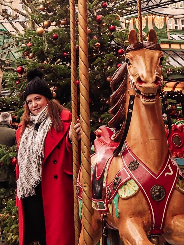 Girl in red coat at carousel at Hamburg Christmas Markets