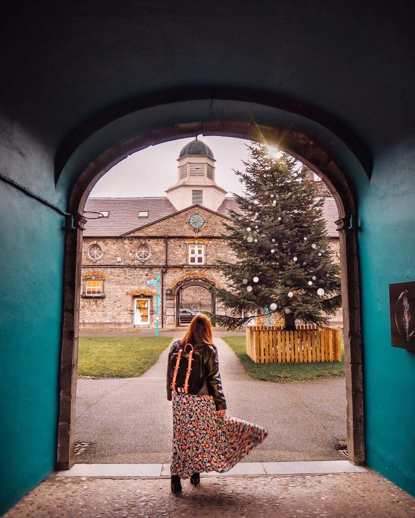 Girl standing in front of Christmas Tree with a Gaston Luga backpack in Kilkenny Ireland