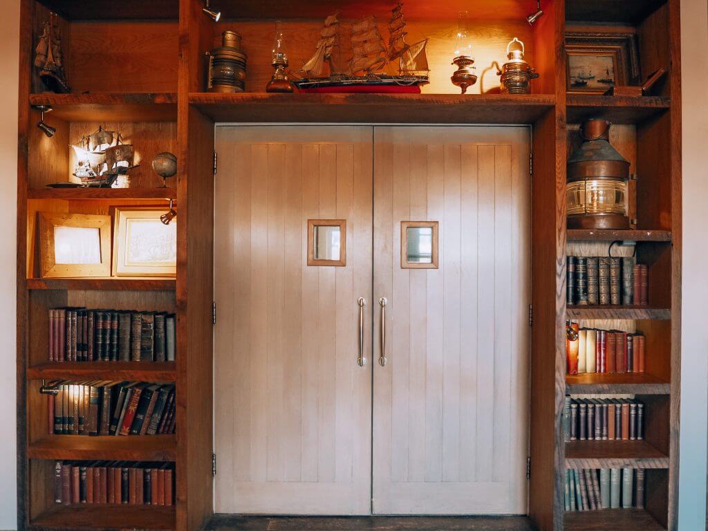 Doorway surrounded by shelving containing books