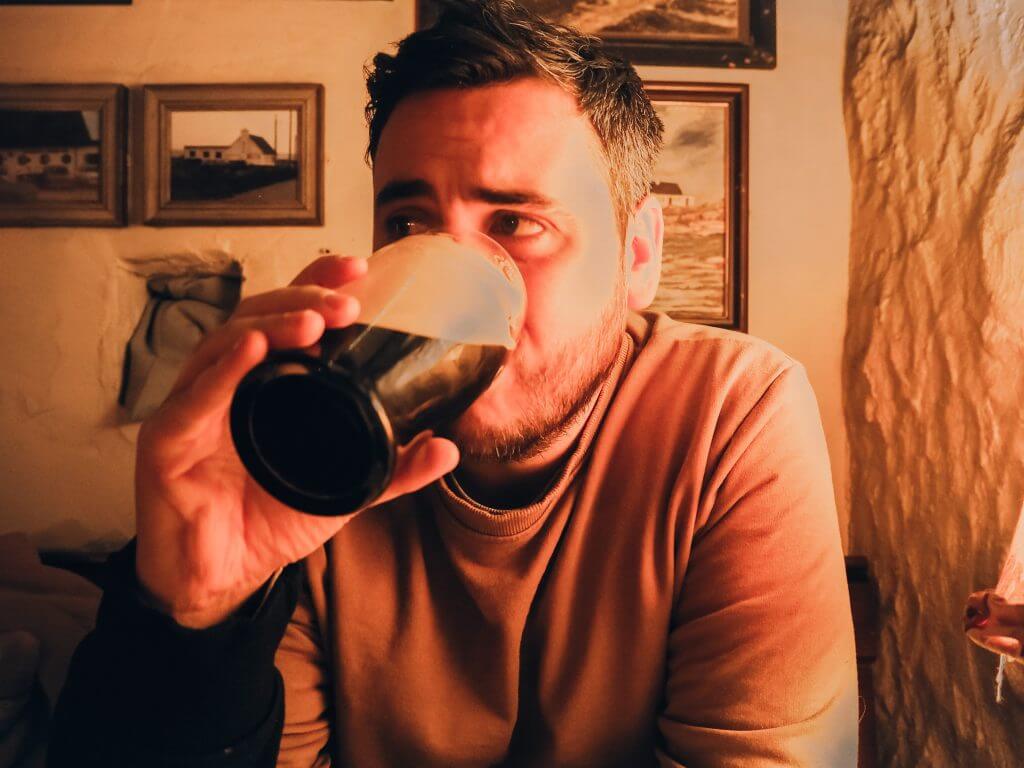 Man drinking a pint of Guinness in Ireland