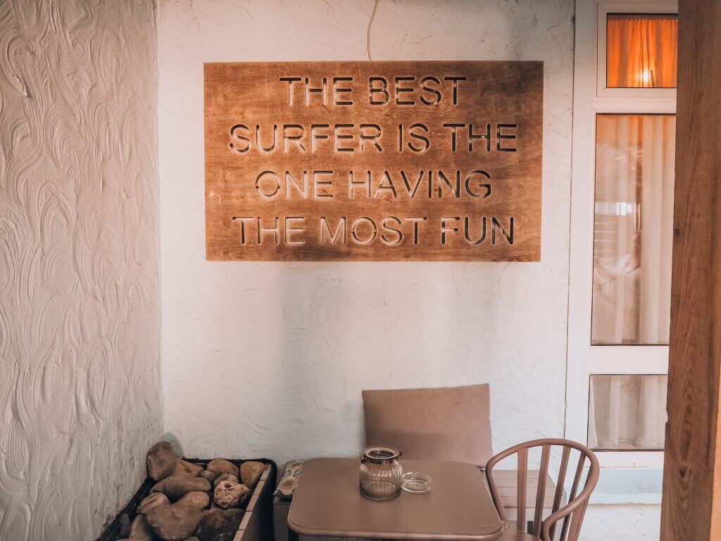 Copper Sign in a Restaurant that reads the best surfer is the one having the most fun
