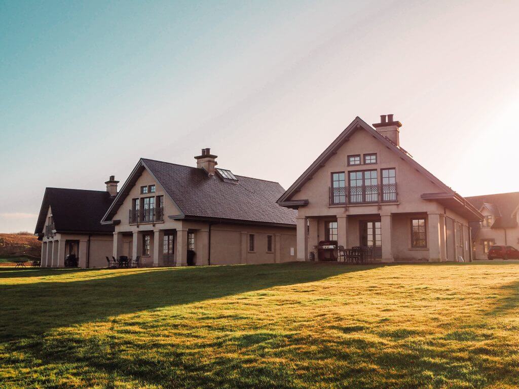 Three houses side by side on a green grass lawn