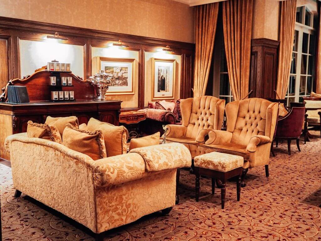 Cream textured couch and two armchairs in the lobby of Lough Erne resort in Northern Ireland