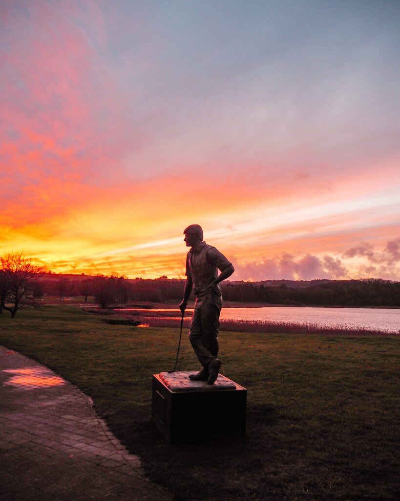 Statue of Nick Faldo at Lough Erne Golf Resort silhouetted against a magical sunset