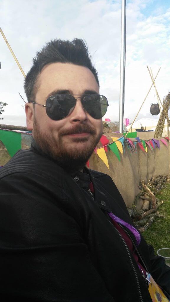 Man wearing a leather jacket and sunglasses at an Irish Music Festival