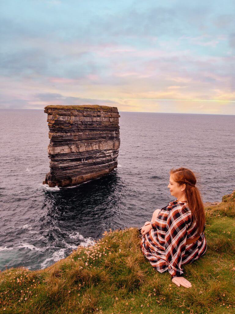 Woman sightseeing at Downpatrick Head in Ireland