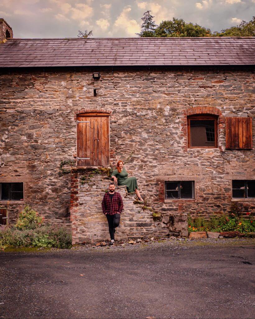 Couple posing at a barn in Dunmore House and Gardens in Carrigans Donegal perfect if you are looking for staycation ireland ideas.
