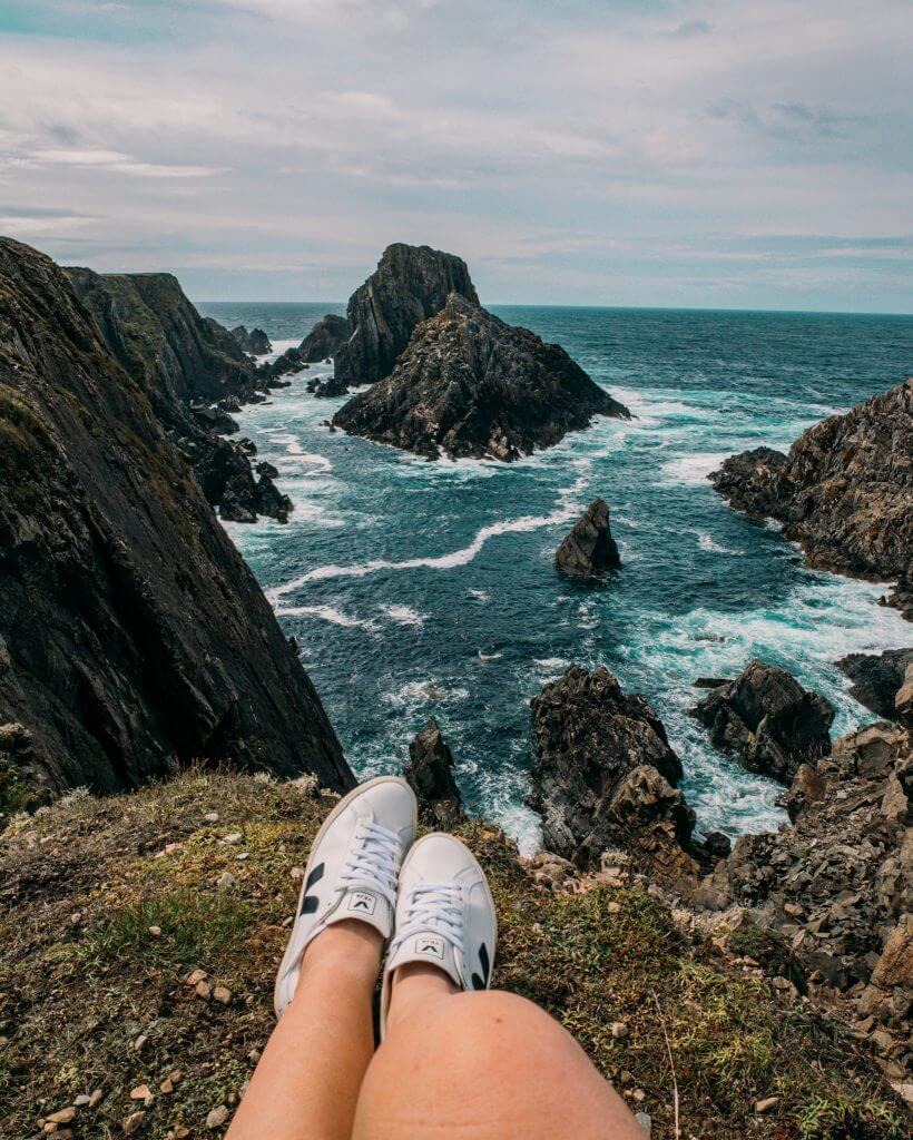 woman's feet with a background view of Malin Head in Donegal Ireland