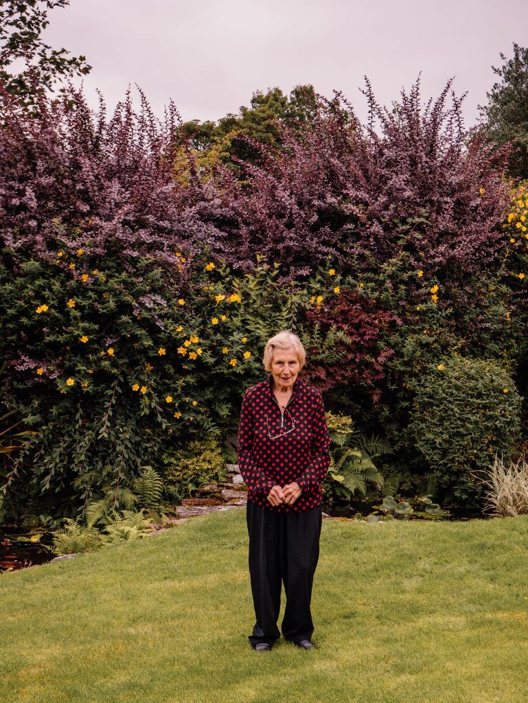 Elderly lady standing in Shekina Sculpture Garden in Wicklow Ireland