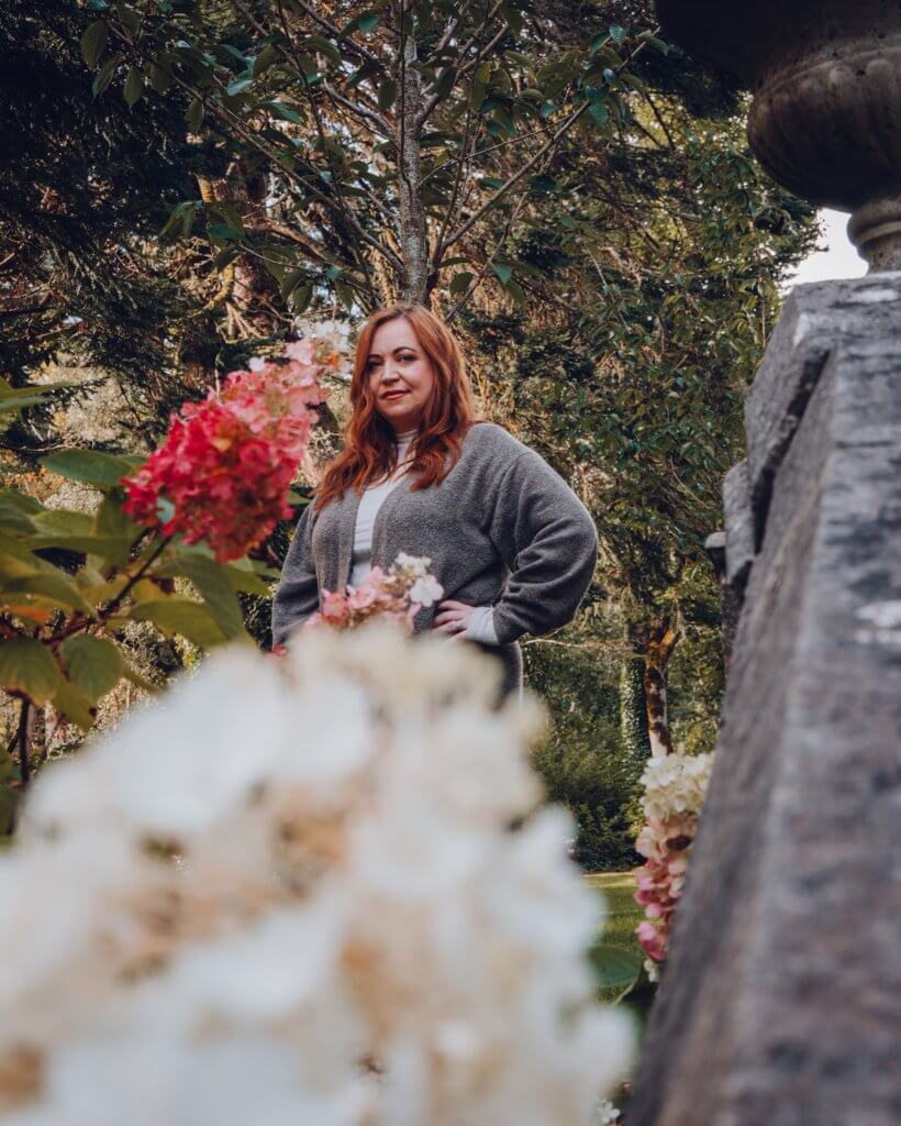 Woman in a flower garden at a luxury hotel in Ireland