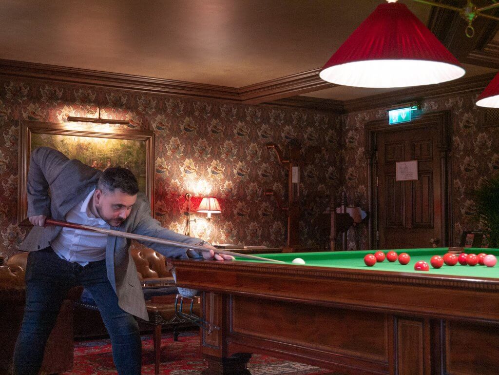 Man playing billiards in a five star hotel in Ireland. Luxury travel Ireland