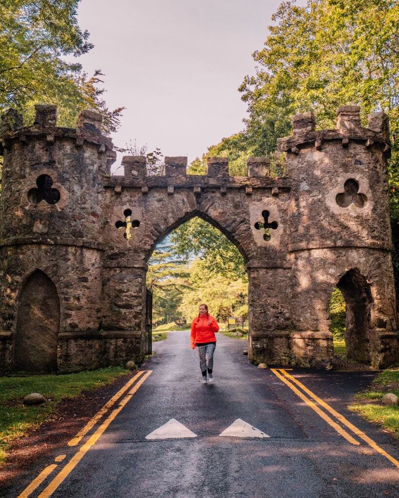 Woman walking at the entrance to Tollymore forest a game of thrones filming location in County Down Northern Ireland