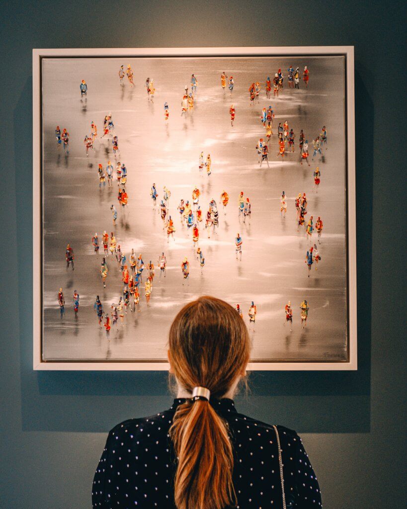 Woman looking at a Stephen Forbes painting at the Art & Soul exhibit in Culloden Estate