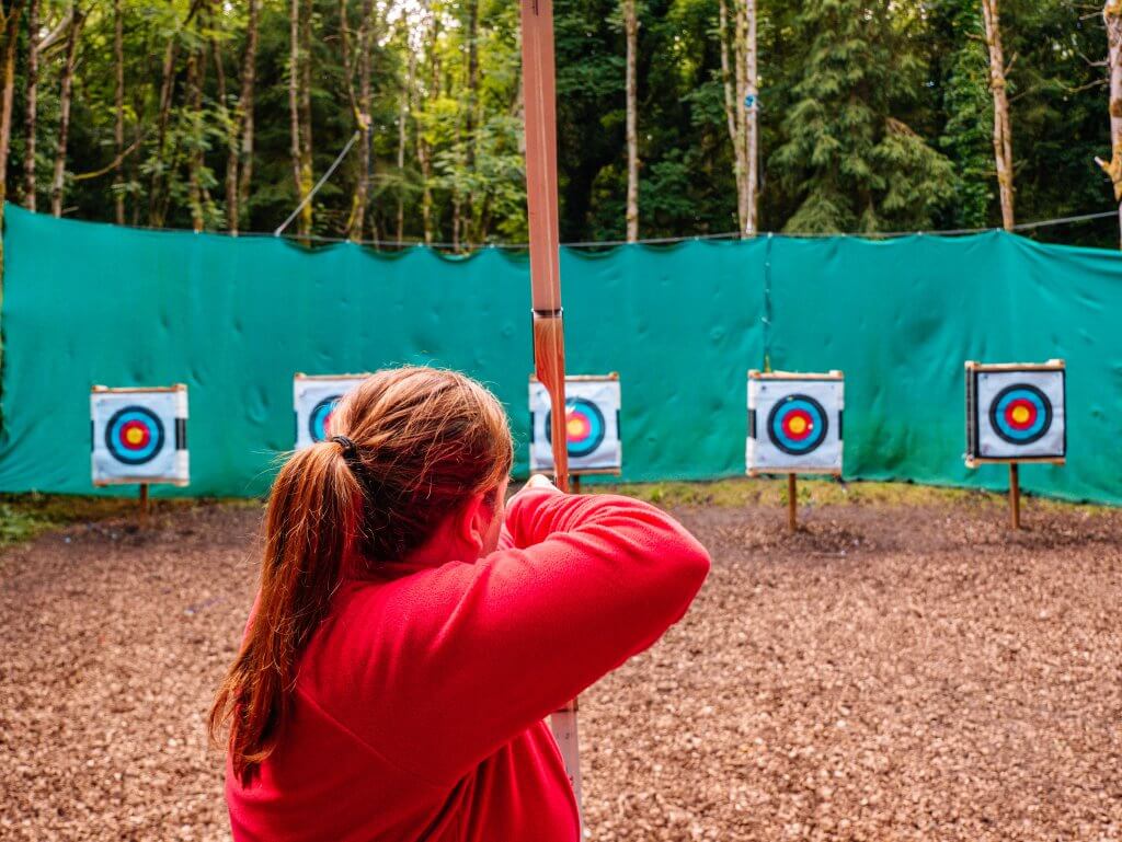 Woman trying archery at Castlecomer Discovery Park in Kilkenny Ireland
