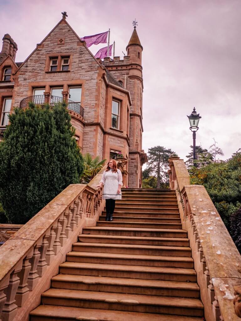 Woman standing on the steps of the five star Culloden Estate and Spa