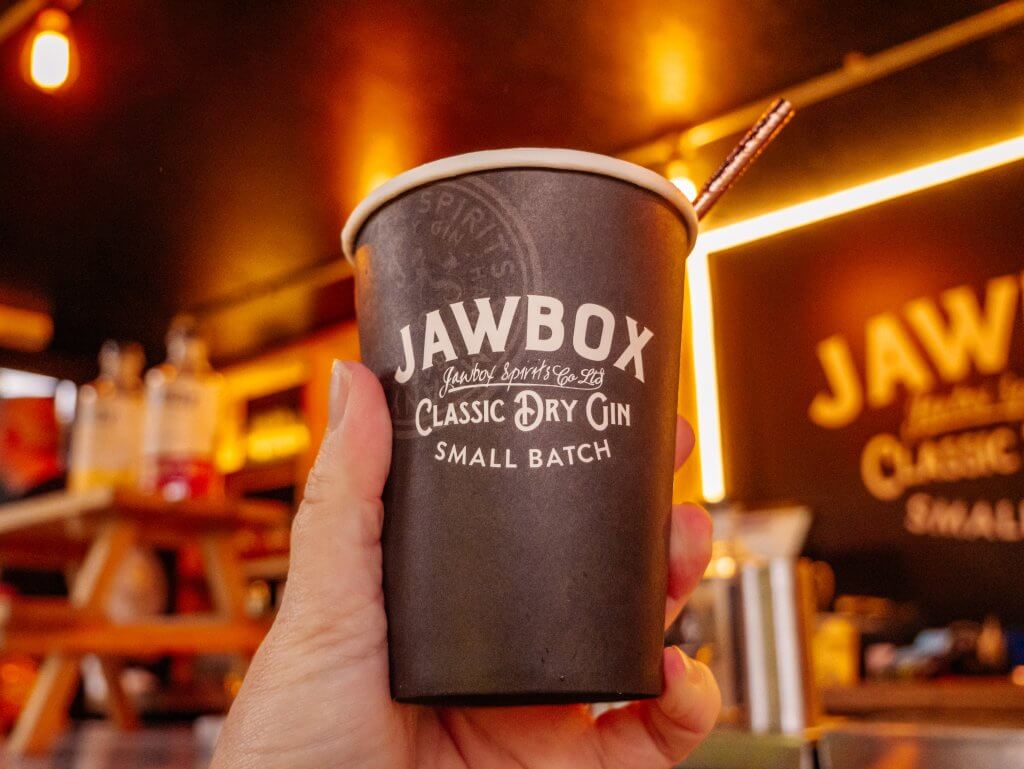 Woman holding a cup of Jawbox Gin