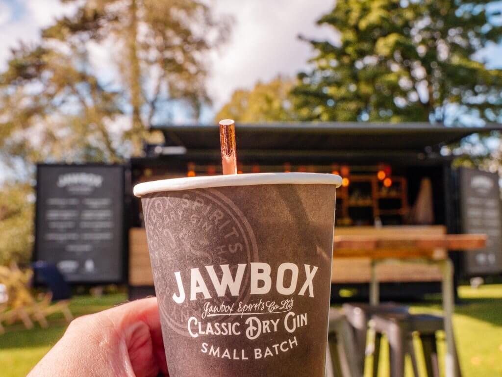 Man holding up a cup of Jawbox Gin
