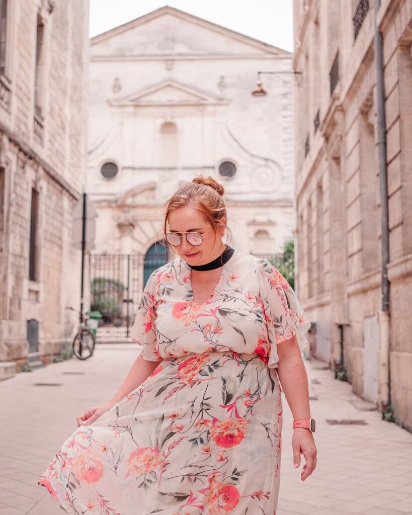 Woman walking in front of a protestant church with a blue door at Rue des Palanques in Bordeaux France