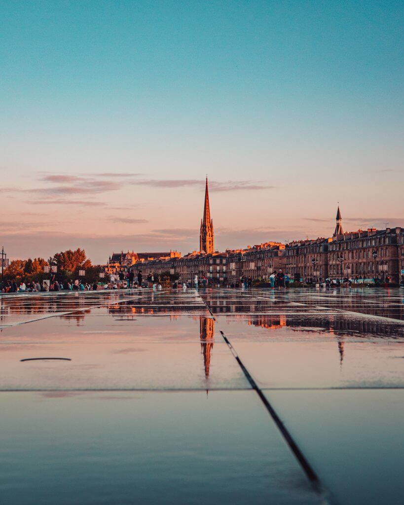 Reflection of a church steeple in Miroir d'eau one of the best Instagram spots in Bordeaux
