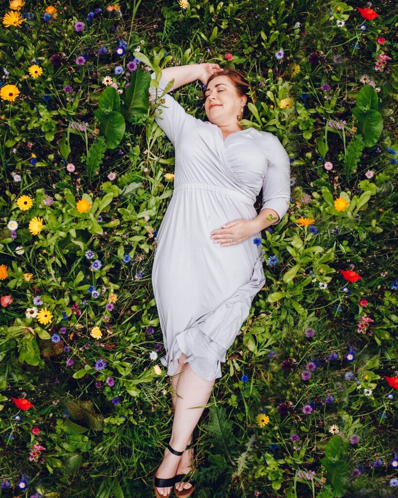 Woman lying in a wildflower garden at Glenarm Castle in Antrim