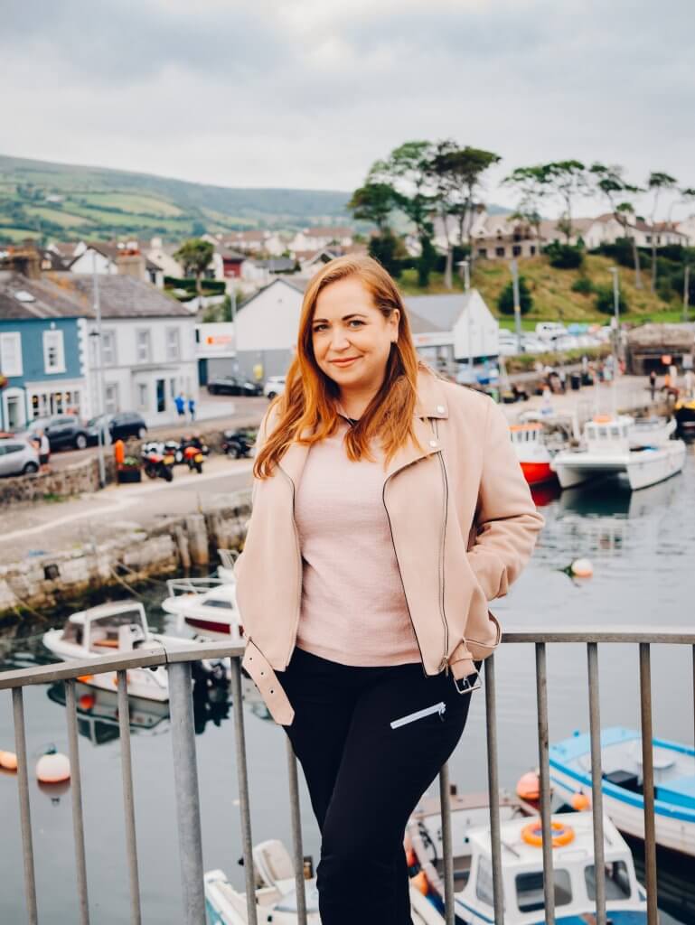 Woman standing at Carnlough Harbour in County Antrim