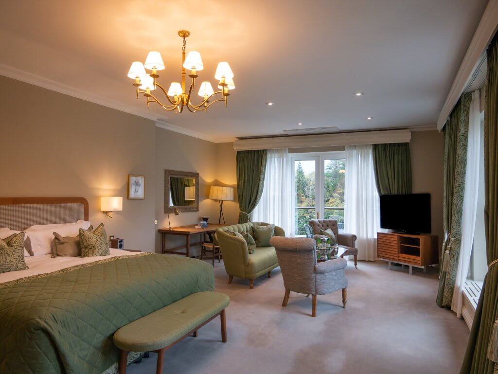 Luxurious guest room at Sheen Falls Lodge, featuring modern amenities and panoramic views of the surrounding landscape.