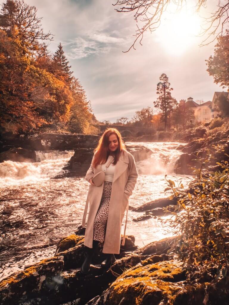 Woman standing near Sheen falls waterfall in Kenmare Kerry Ireland