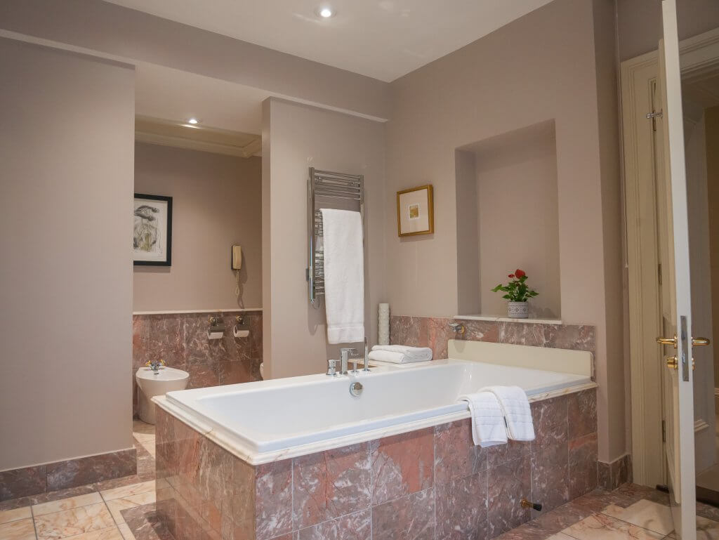 Luxurious bathroom at Sheen Falls Lodge, featuring elegant design and upscale amenities for guests' comfort.