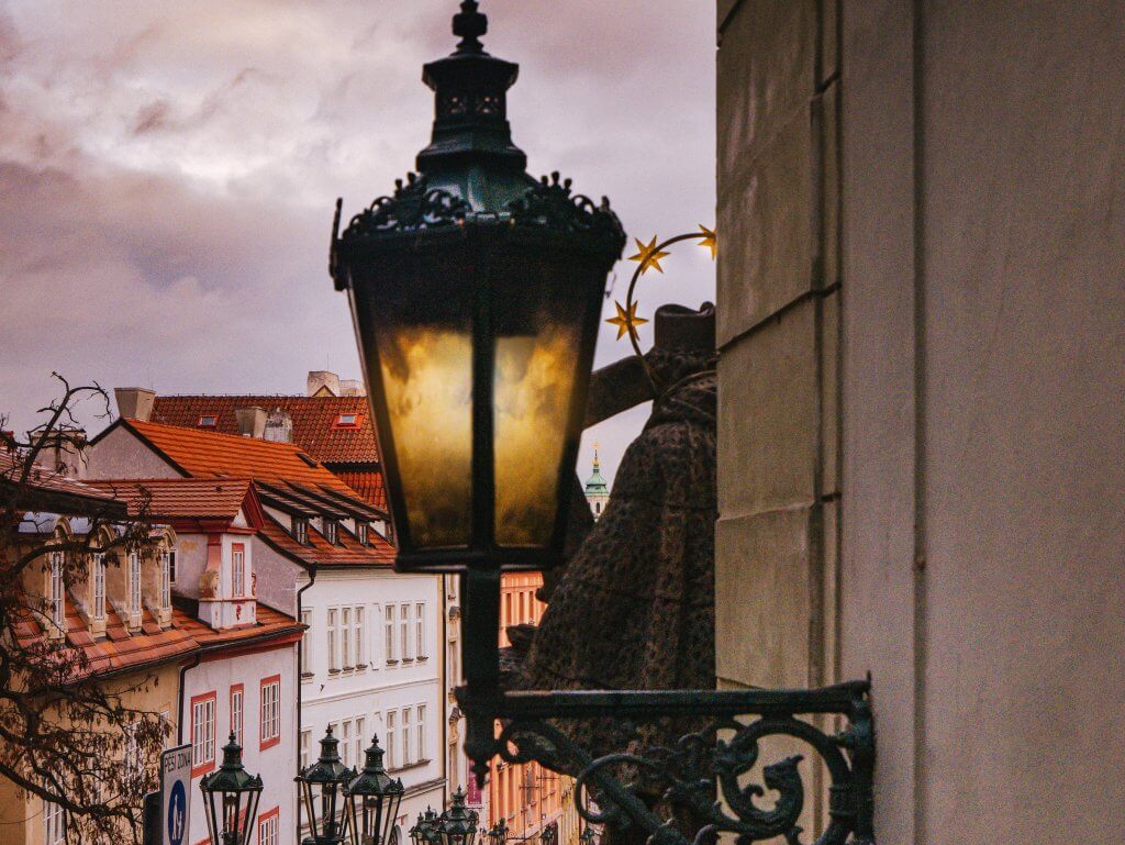 Gothic lantern overlooking rooftop views of Prague city