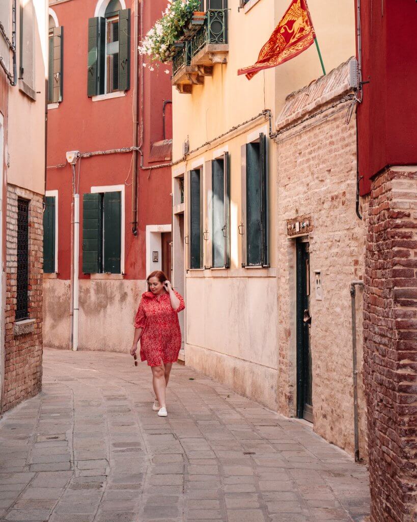 Woman walking the rustic streets of Castello Venice, a hidden Instagram spot in Venice