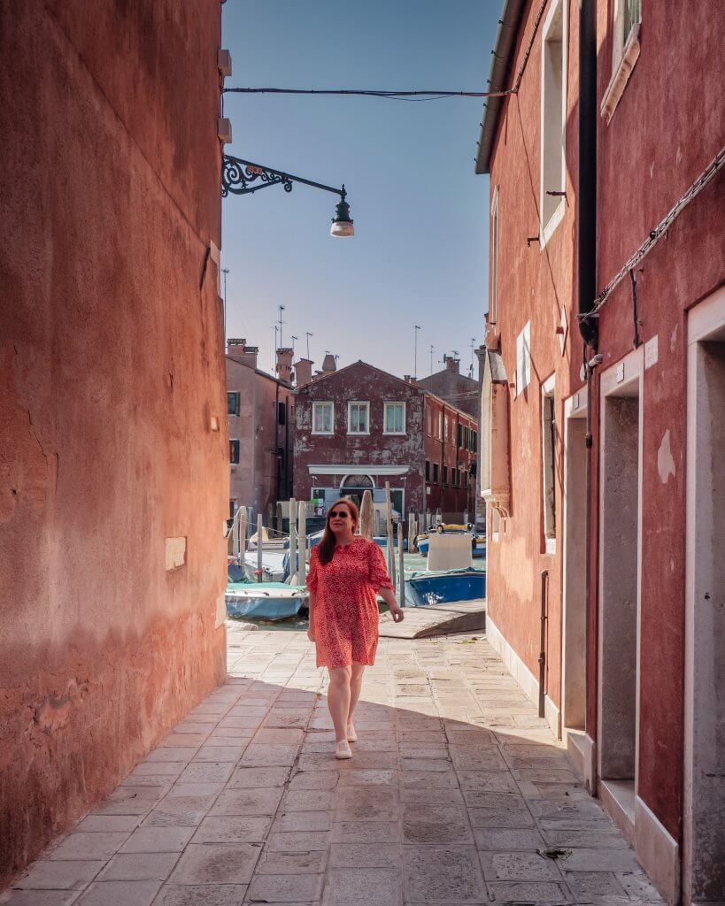 Woman with chronic illness walking along the cobbled streets of San Pietro Island a hidden gem in Venice Italy